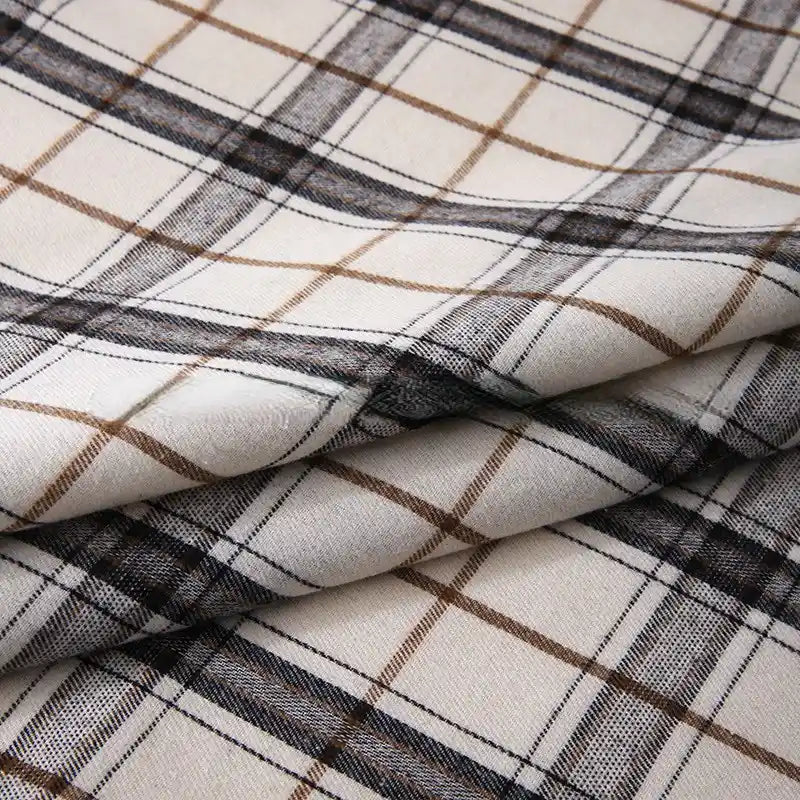 Folded Longan Craft “Colorful One Side Sueded Flannel Fabric By The Yard”—a super snuggle, yarn-dyed cotton plaid flannel—features a soft, layered material with a checkered beige, brown, and black pattern on a white background.