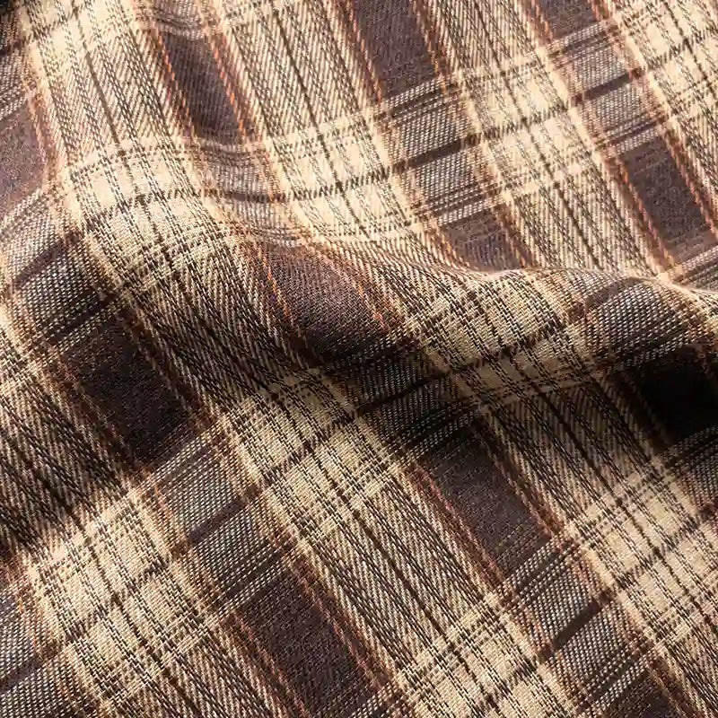 Close-up of Longan Craft’s Colorful One Side Sueded Yarn Dyed Cotton Plaid Flannel Fabric by the yard, featuring a soft, slightly rumpled texture and intersecting brown and beige lines for a classic super snuggle fall look.