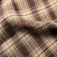 Close-up of Longan Craft’s Colorful One Side Sueded Yarn Dyed Cotton Plaid Flannel Fabric by the yard, featuring a soft, slightly rumpled texture and intersecting brown and beige lines for a classic super snuggle fall look.