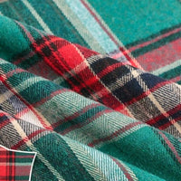 Close-up of Longan Craft’s Colorful One Side Sueded Flannel Fabric By The Yard, featuring yarn-dyed cotton plaid in intersecting red, green, navy, and white stripes with a soft texture and gentle overlapping folds—perfect as a super snuggle fall flannel material.