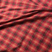 The Colorful One Side Sueded Flannel Fabric By The Yard from Longan Craft features a red, yellow, and black yarn-dyed plaid pattern with intersecting lines. This super snuggle fall flannel material showcases visible folds and a soft, sueded texture, making it perfect for cozy projects.