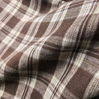 Close-up of Longan Craft’s Colorful One Side Sueded Flannel Fabric By The Yard, a super snuggle fall material featuring a brown and beige yarn-dyed cotton plaid pattern with intersecting lines and a softly textured, gently wrinkled surface.