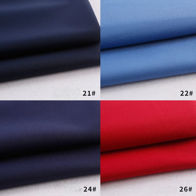 Four swatches of Longan Craft Colorful Rayon Polyester Blend Gabardine Fabric—navy blue (21#), light blue (22#), dark blue (24#), and red (26#)—are shown on a white surface, each labeled with its number.