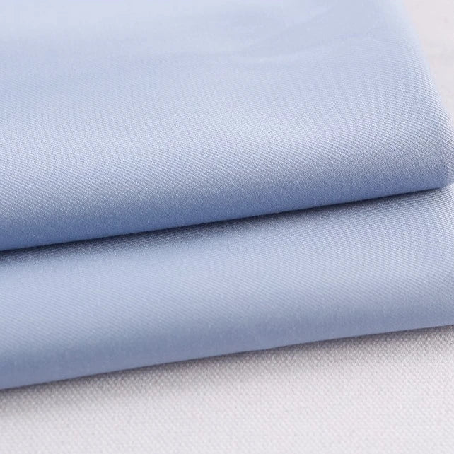 Two neatly folded pieces of Longan Craft Colorful Rayon Polyester Blend Gabardine Fabric, heavyweight with a soft texture and fine weave, ideal for DIY uniforms.