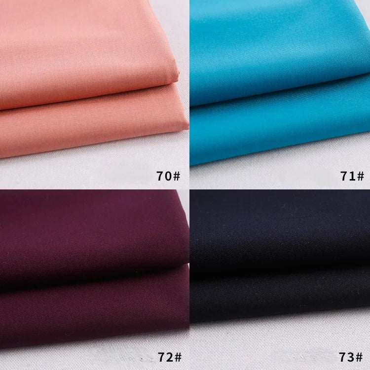 Four folded panels of Longan Craft Colorful Rayon Polyester Blend Gabardine Fabric in peach (70#), bright blue (71#), deep maroon (72#), and black (73#), each labeled with its number in the bottom right corner.