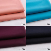 Four folded panels of Longan Craft Colorful Rayon Polyester Blend Gabardine Fabric in peach (70#), bright blue (71#), deep maroon (72#), and black (73#), each labeled with its number in the bottom right corner.