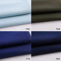 Four Colorful Rayon Polyester Blend Gabardine fabric swatches by Longan Craft are shown in light blue (74#), olive green (76#), dark blue (77#), and navy blue (78#), each neatly folded and numbered in the bottom right corner.