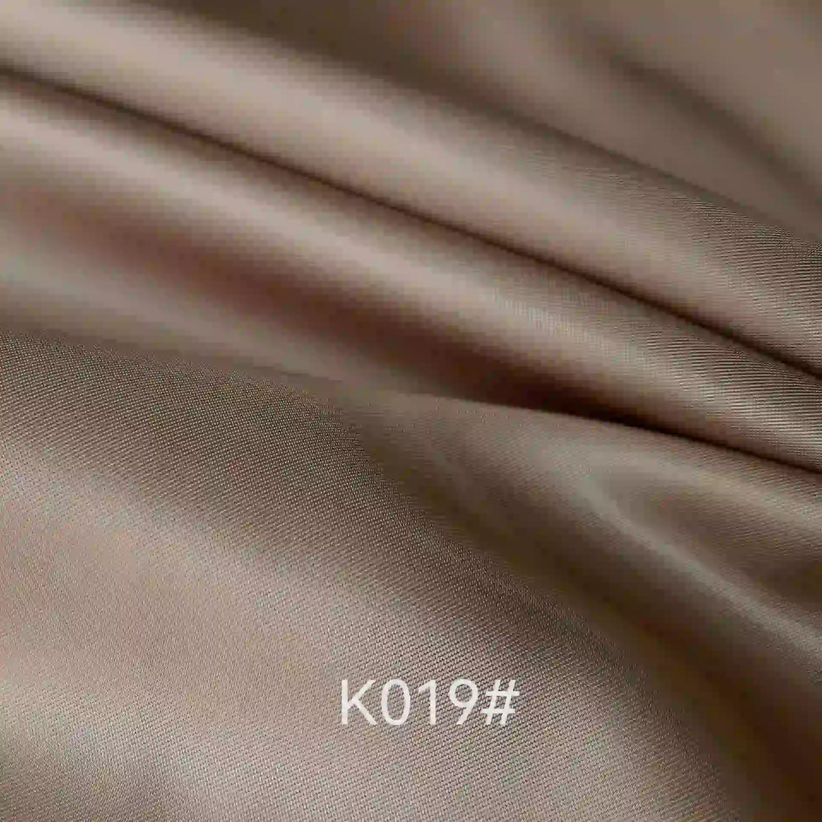 Elegant beige polyester viscose satin fabric with a twill weave and soft sheen by Longan Craft; ideal for formal dresses. "K019#" is printed at the bottom center of the image.