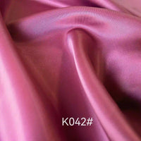 Longan Craft’s Colorful Satin Viscose Fabric By The Yard features a twill weave, lustrous finish, and silky texture, making it ideal for formal dresses. "K042#" appears at the bottom center of the image.