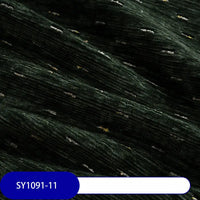 Close-up of Colorful Slub Chenille Fabric by Longan Craft in dark green with ribbed, speckled texture and scattered white and yellow threads. Soft, plush heavyweight chenille for home decor is shown with code SY1091-11 on a blue label.