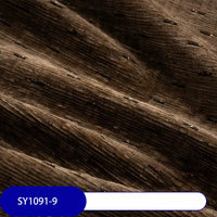 Close-up of Longan Craft’s Colorful Slub Chenille Fabric By The Yard, a heavyweight, slubby-textured chenille material in rich brown with vibrant flecks. Featured is the soft upholstery fabric gently folded, label SY1091-9 visible at the bottom.