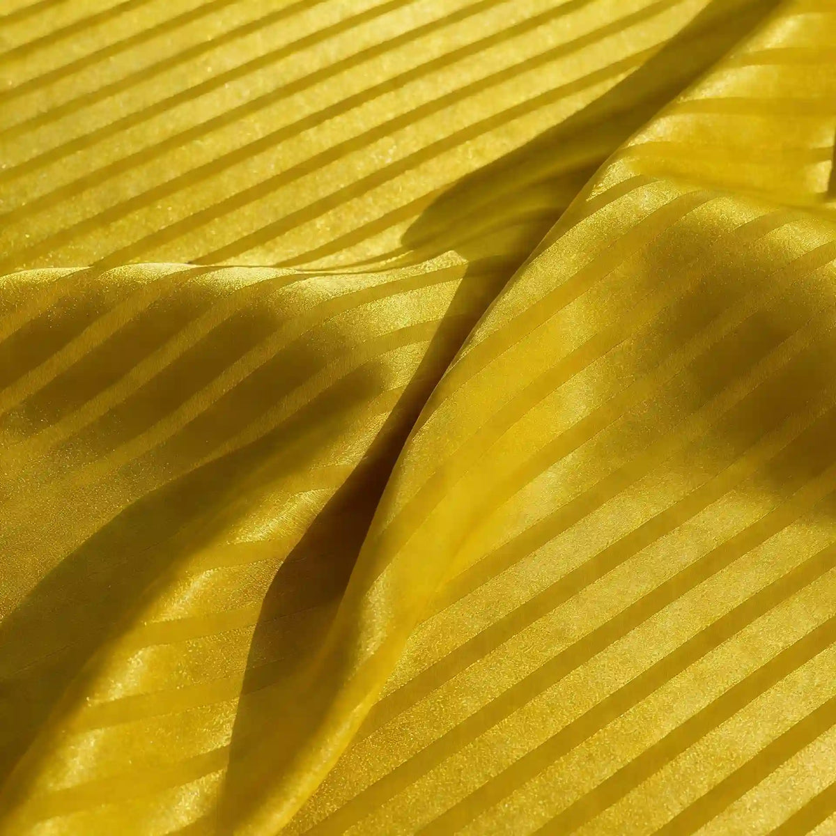 Close-up of Longan Craft Colorful Striped Jacquard Satin Fabric By The Yard, a smooth and breathable shiny polyester material with alternating glossy and matte stripes, softly draped to highlight its vibrant texture for dressmaking.