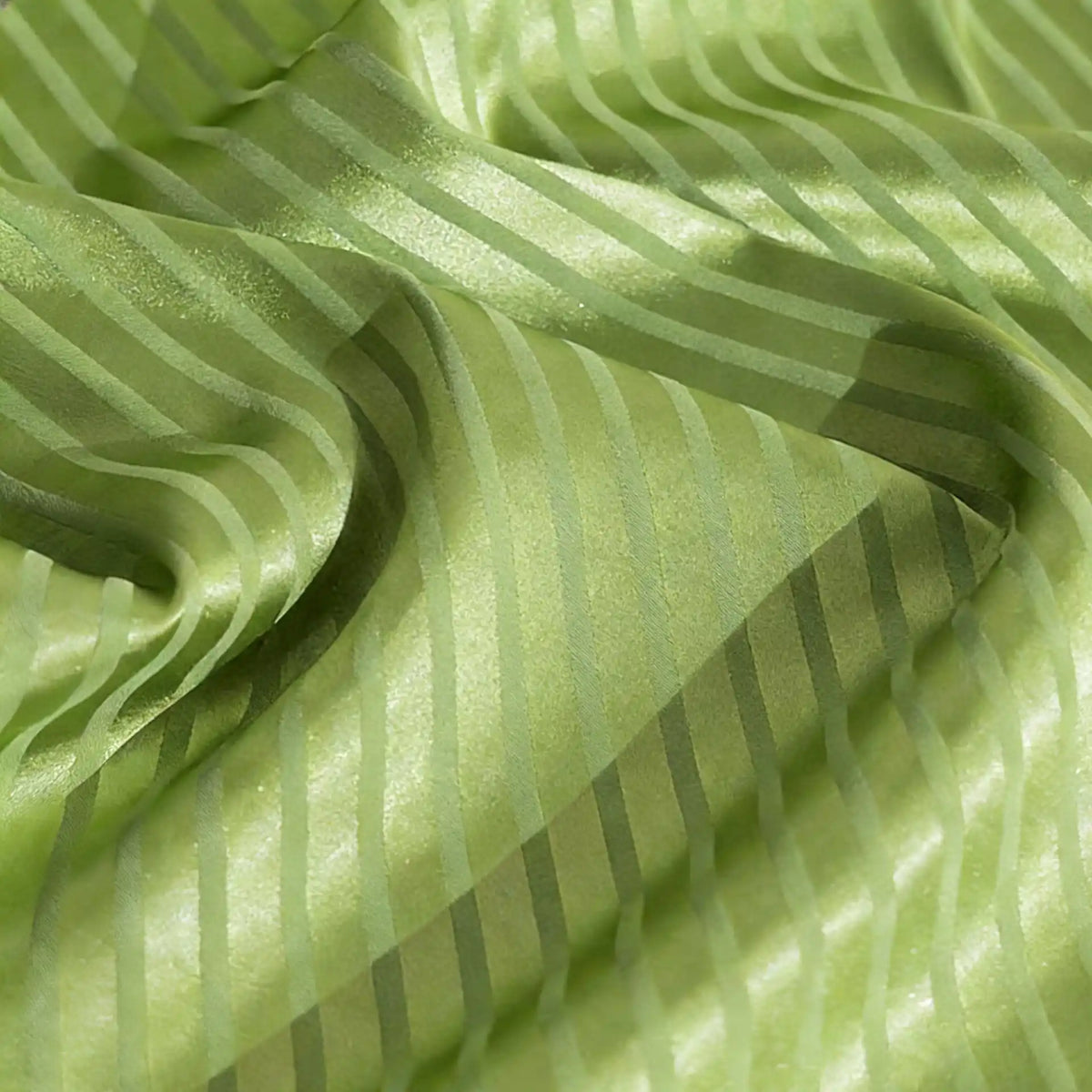 A close-up of Longan Craft’s Colorful Striped Jacquard Satin Fabric by the yard shows shiny, smooth polyester with vibrant stripes, featuring light-reflecting folds and a breathable texture ideal for dressmaking.