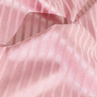 Close-up of Longan Craft’s Colorful Striped Jacquard Satin Fabric by the yard, featuring shiny pink vertical stripes and gentle folds—smooth, breathable polyester ideal for dressmaking.