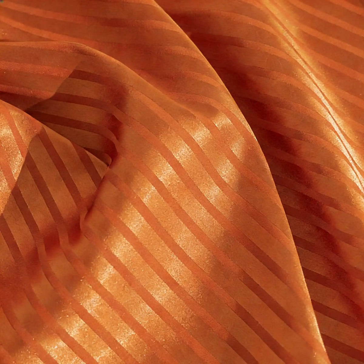 Close-up of Longan Craft’s Colorful Striped Jacquard Satin Fabric by the yard, a shiny polyester with diagonal stripes and a smooth, breathable texture—ideal for dressmaking projects that need depth and movement.