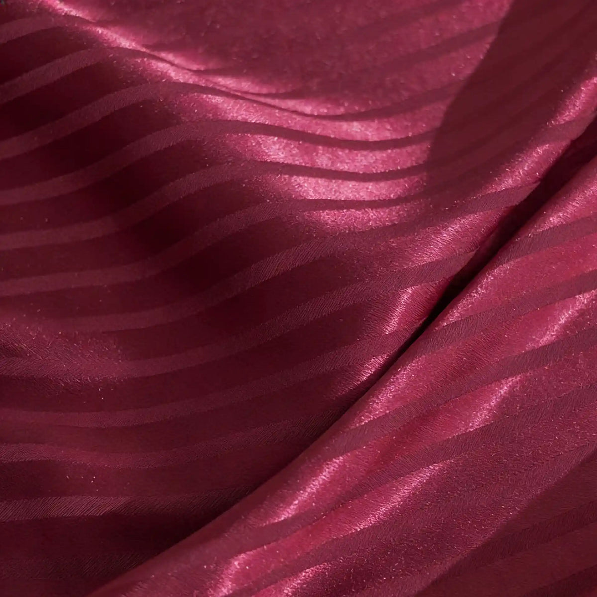 Close-up of Longan Craft’s Colorful Striped Jacquard Satin Fabric by the Yard, featuring shiny polyester stripes, soft folds, and a smooth, breathable texture ideal for dressmaking.