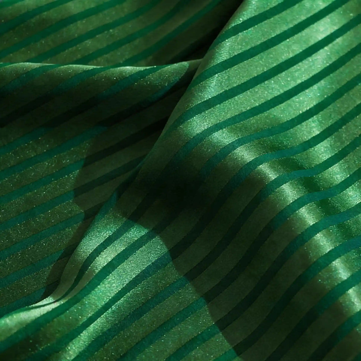 Longan Craft’s Colorful Striped Jacquard Satin Fabric by the Yard features shiny, smooth polyester with dark green diagonal stripes and soft folds, creating a textured, reflective surface—perfect for dressmaking and crafts.