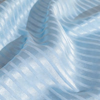 Close-up of Longan Craft Colorful Striped Jacquard Satin Fabric By The Yard, a shiny polyester stripe satin material with smooth, breathable texture and gentle folds—ideal for dressmaking.