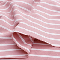 A close-up of Longan Craft’s Colorful Striped Stretch French Terry fabric shows soft pink cotton-spandex knit with horizontal white stripes, perfect for sweatshirts and activewear. Fabric is gently folded, creating subtle curves and shadows.