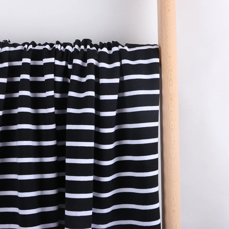 Longan Craft’s Colorful Striped Stretch French Terry Fabric by the yard is draped over a light wooden rod, showing its knit cotton-blend material and bold horizontal stripes against a plain white background—ideal for sweatshirts.