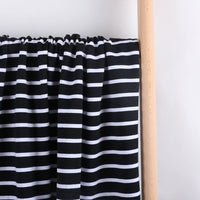 Longan Craft’s Colorful Striped Stretch French Terry Fabric by the yard is draped over a light wooden rod, showing its knit cotton-blend material and bold horizontal stripes against a plain white background—ideal for sweatshirts.