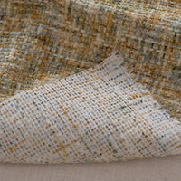 A close-up of Longan Craft’s Colorful Tweed Chenille Fabric by the Yard shows its soft, textured weave in yellow, white, green, and grey checks—perfect for stylish clothing or upholstery projects.