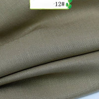 Close-up of Longan Craft's Colorful Twill 100 Lyocell Fabric by the yard, featuring fine diagonal weave and khaki color. A white label marked "12#" appears in the upper right corner. Sustainable and comfortable material for suits.