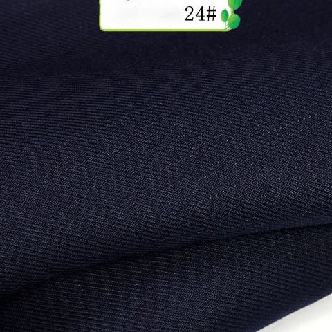 Close-up of Longan Craft's Colorful Twill 100 Lyocell Fabric By The Yard, in dark navy blue with a smooth, subtly textured surface. A small label marked "24#" with green accents appears in the top right corner.
