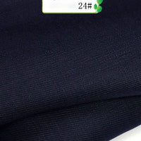 Close-up of Longan Craft's Colorful Twill 100 Lyocell Fabric By The Yard, in dark navy blue with a smooth, subtly textured surface. A small label marked "24#" with green accents appears in the top right corner.