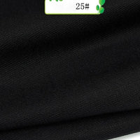 Close-up of Longan Craft’s Colorful Twill 100 Lyocell Fabric, a smooth black textile with fine diagonal lines. A small green and white “25#” label appears at the edge, highlighting this sustainable fabric for suits.