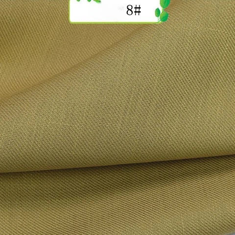 A close-up of folded khaki Colorful Twill 100 Lyocell Fabric by Longan Craft shows its fine, slightly textured sustainable weave. The top corner displays a small white label with green accents and the number 8#.
