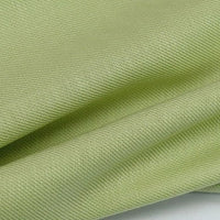 A close-up of Longan Craft’s Colorful Twill Lyocell Fabric By The Yard shows its light green, finely woven 100% lyocell material with a subtle textured pattern—an eco-friendly, comfortable choice for suits and other garments.