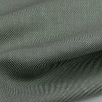 A close-up of Longan Craft’s Colorful Twill Lyocell Fabric By The Yard shows its grey, sustainable 100% lyocell weave and soft folds, highlighting the comfortable texture ideal for suits.