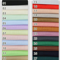 A chart shows 27 Longan Craft Colorful Viscose Challis Fabric By The Yard swatches in two columns, each numbered. These lightweight, breathable polyester viscose fabrics feature a range of neutral, pastel, and deep tones for sun protection shirts.