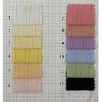 Twelve swatches of Longan Craft’s Colorful Viscose Dobby Fabric, a cotton-rayon jacquard blend for DIY dresses, are shown in pastel and dark shades (white, yellow, pink, purple, green, black) on a grid background labeled 1-12.