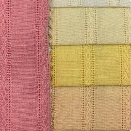Five pieces of Longan Craft's Colorful Viscose Dobby Fabric—a cotton-rayon blend with jacquard patterns—are stacked in pastel shades, each showing a soft textured finish, perfect for DIY dresses.