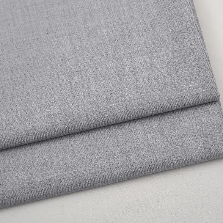 Folded light gray Colorful Worsted Wool Fabric By The Yard with a fine, woven texture.