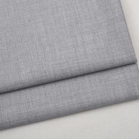 Folded light gray Colorful Worsted Wool Fabric By The Yard with a fine, woven texture.