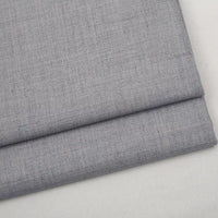 Folded light gray Colorful Worsted Wool Fabric By The Yard with a subtle woven texture.