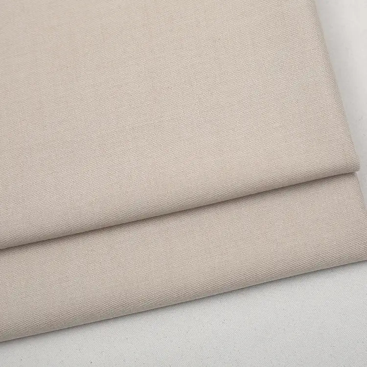 Folded light beige Colorful Worsted Wool Fabric By The Yard with a tight woven texture.