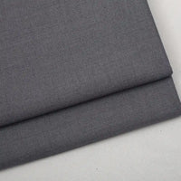 Folded piece of dark gray Colorful Worsted Wool Fabric By The Yard with a woven texture.