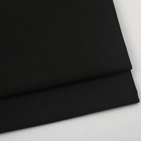 A folded piece of Colorful Worsted Wool Fabric By The Yard in solid black.
