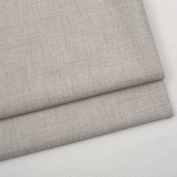 A folded piece of light beige Colorful Worsted Wool Fabric By The Yard in a fine-weave, premium texture.