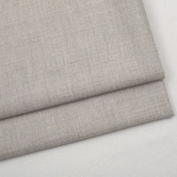 A folded piece of light beige Colorful Worsted Wool Fabric By The Yard in a fine-weave, premium texture.