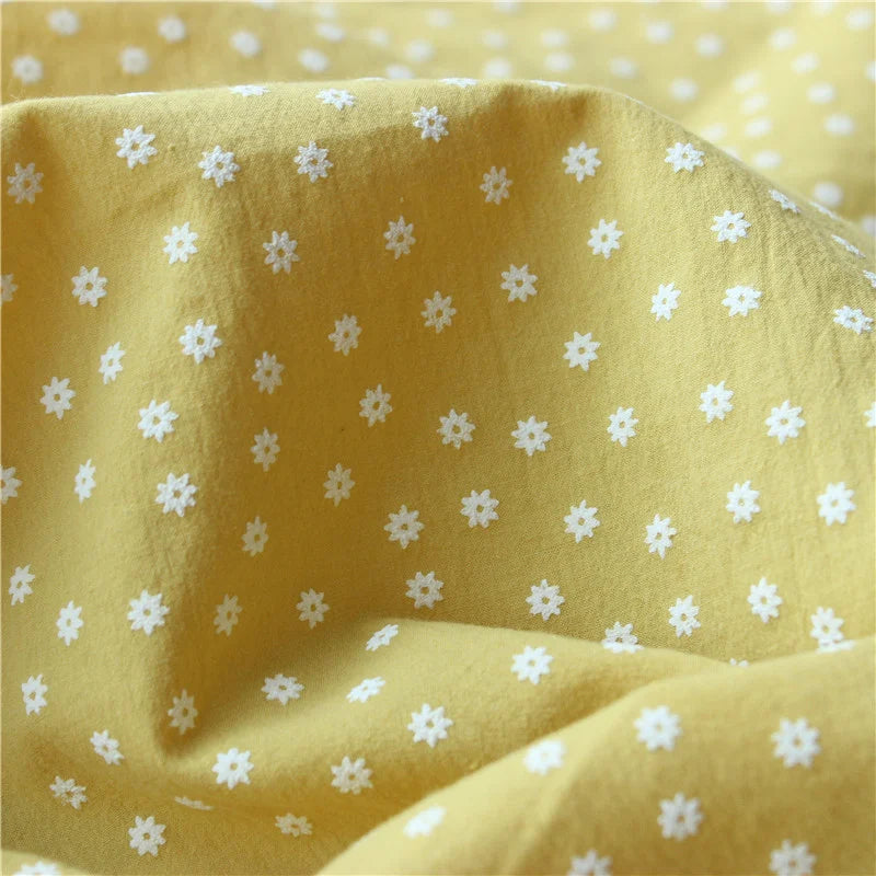 Close-up of Longan Craft’s Cotton Floral Printed Voile Fabric By The Yard shows a soft, breathable voile with a multicolor washed flower print. This cozy material features gentle folds and texture, ideal for casual wear.