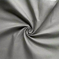 Close-up of Longan Craft's Cotton Gabardine Fabric By The Yard, a lightweight twill with a soft texture and subtle sheen, breathable for shirt making and shown twisted into a spiral to highlight its quality.