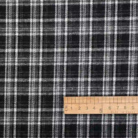 Longan Craft’s Cotton Gingham Sueded Flannel Fabric By The Yard features a multicolor checked pattern, shown here with a wooden ruler positioned horizontally along the bottom right edge, displaying centimeter measurements from 5 to 14. The comfy shirting flannel’s distinctive grid contrasts with the ruler’s straight lines.