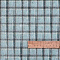 A yard of Longan Craft’s Cotton Gingham Sueded Flannel Fabric, featuring a comfy multicolor checked polyester design, is shown with a wooden ruler in inches for scale to indicate the size of the pattern.