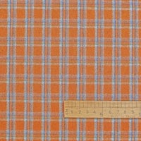 The Cotton Gingham Sueded Flannel Fabric By The Yard from Longan Craft is displayed here featuring a multicolor blue and white check pattern on an orange background. A wooden centimeter-marked ruler at the bottom provides a sense of scale for this comfy polyester flannel material, ideal for shirting and other projects.