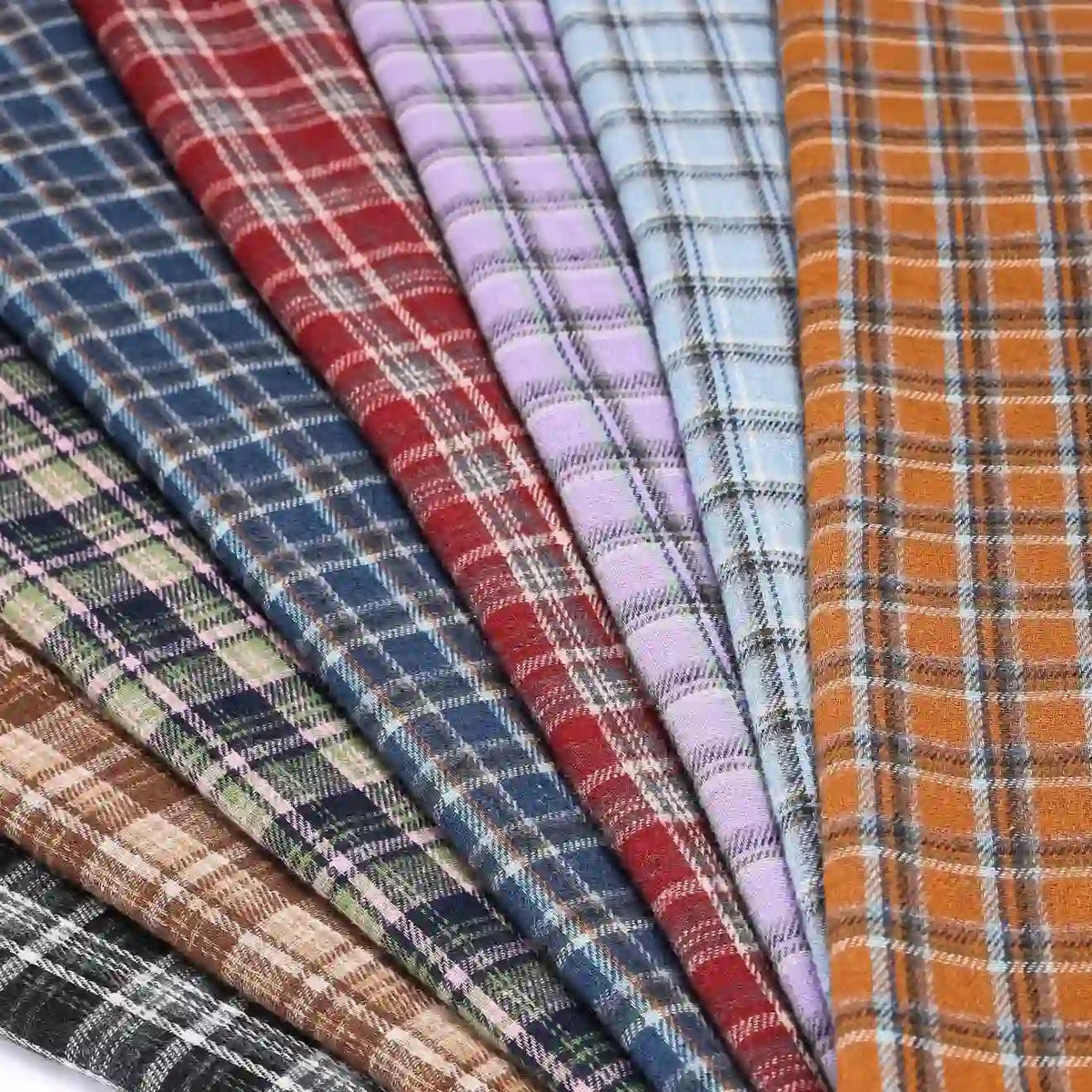 Eight pieces of Longan Craft Cotton Gingham Sueded Flannel Fabric by the yard, featuring multicolor polyester checked patterns in shades like red, blue, purple, yellow, green, brown, and black, are neatly arranged in a fan shape.